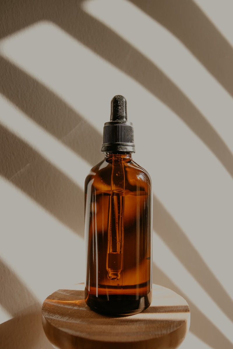 Photo by Kadarius Seegars brown glass bottle on white table